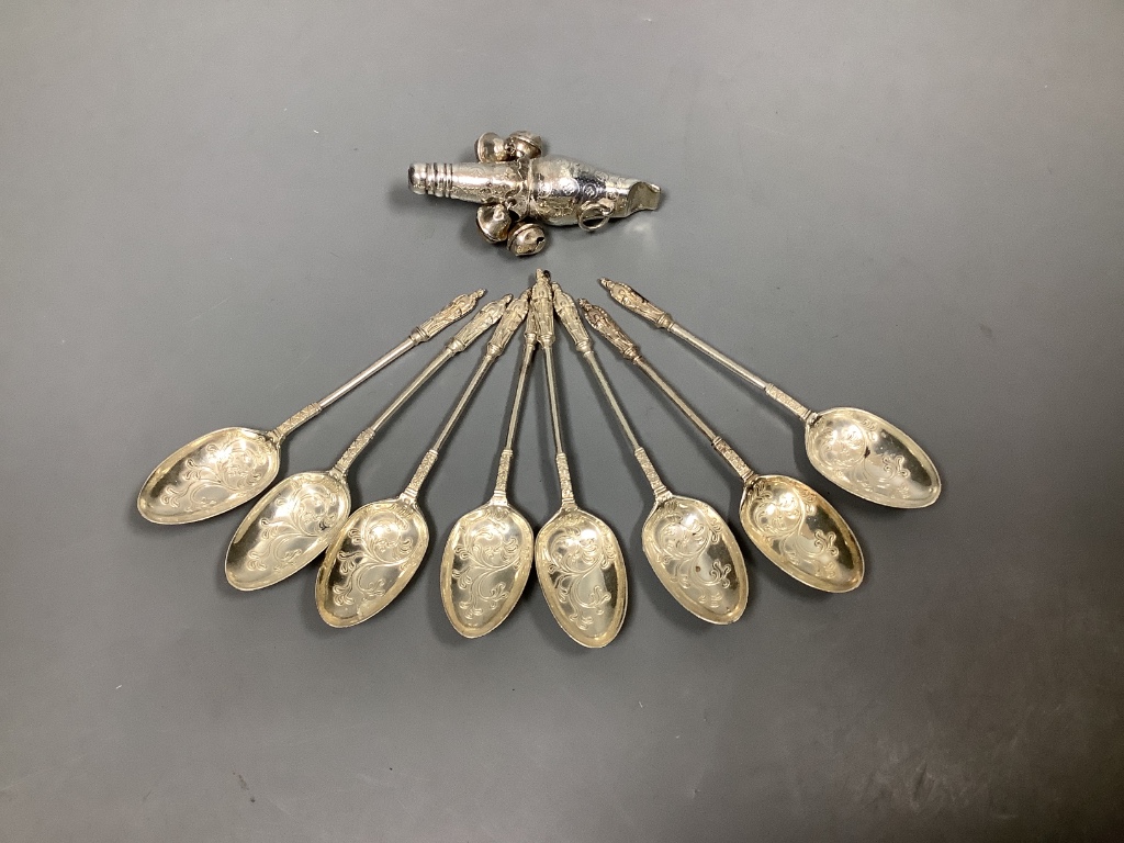 A set of eight late Victorian silver teaspoons, Sheffield, 1898 and a white metal child's rattle (lacking teether).